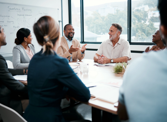 Shot of a group of businesspeople listening to a colleagues ideas during a meeting.